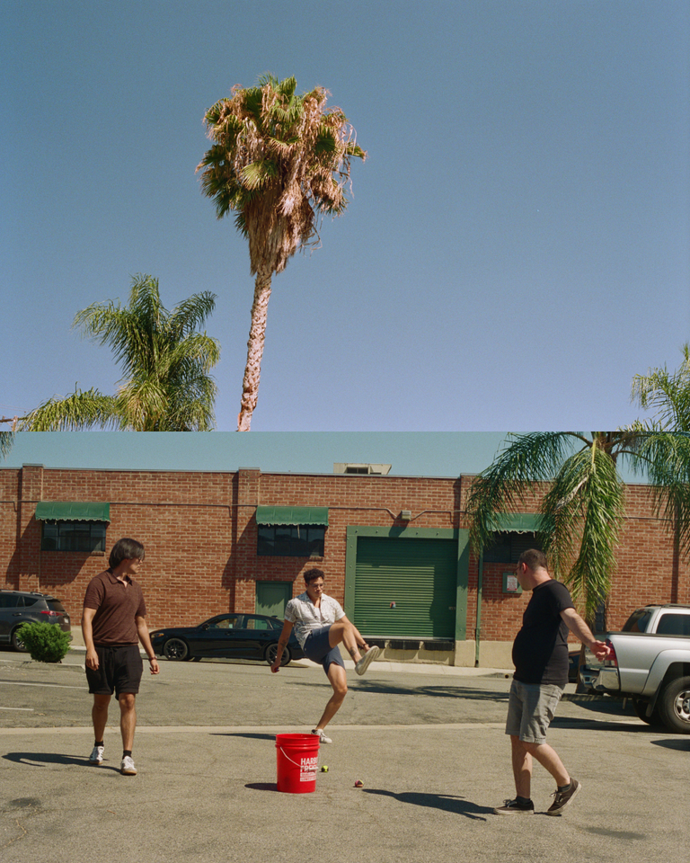 people playing hackysack below a palm tree